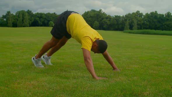 Active Sporty Fitness African American Man Doing Pike Push Ups Outdoors alt