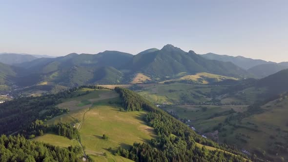 Fly Above Green Countryside Landscape in Alpine Mountains Summer alt