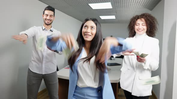 Cheerful Successful Coworkers Scattering Money and Dancing in Office alt