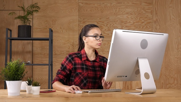 Young casual dressed modern student working on computer. alt
