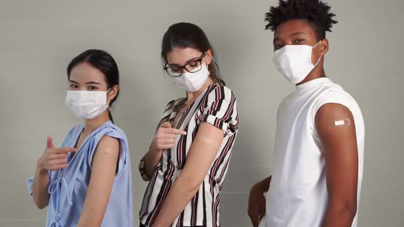 Diverse Group of People Showing COVID19 Vaccine Bandage Merrily alt