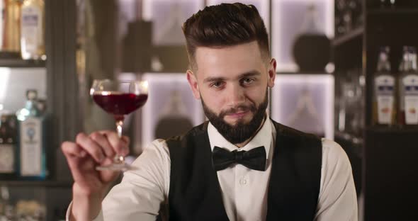 Bartender Is Raising His Glass Looks Camera alt