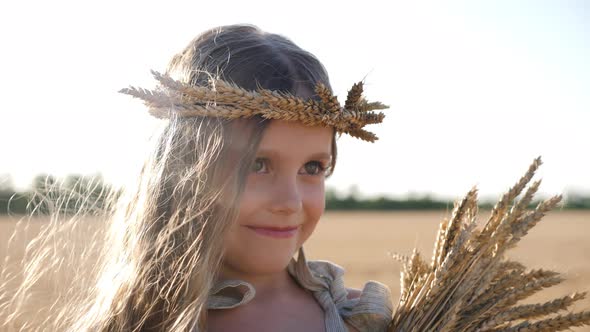 Serious Sad Girl a Child Stands on a Wheat Mown Field alt