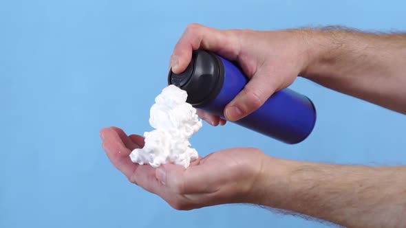 Man Applying Shaving Foam To Hand