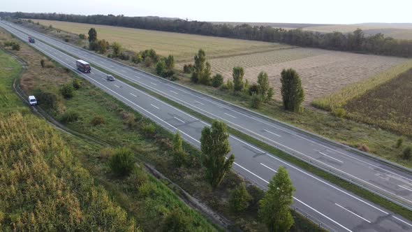 Aerial View of a Truck and Other Traffic Moving Along a Freeway alt