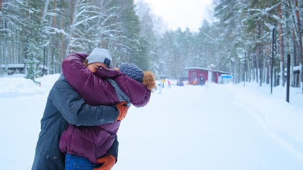 Positive People in Jackets Hug and Join Hands on Ice Rink