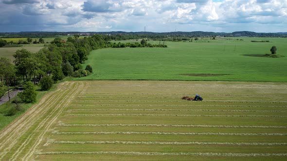 Sweeping Evergreen Plowland With A Tractor Machine Tilling Acres Of Soil In Warmian-Masurian Voivode alt