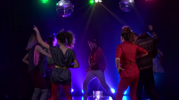 Friends Dancing at a Party Having a Night . Slow Motion . Smoke Background alt