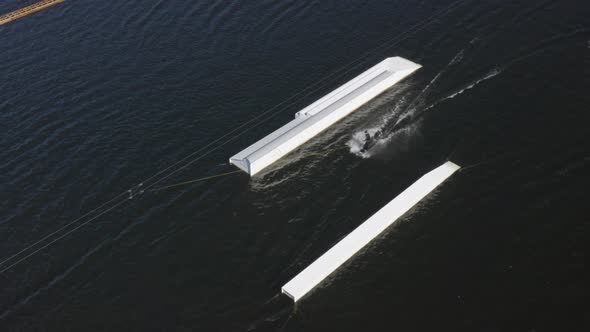 Wakeboarders Jumping Over The Two Surfing Ramps