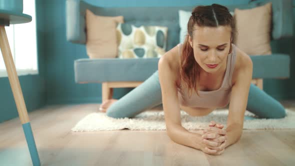 Closeup Expectant Mother Practicing Yoga. Smiling Pregnant Woman Stretching Legs alt