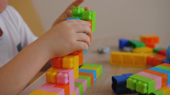 Funny Baby Boy Playing with Colorful Building Blocks Assembling Toy Bricks
