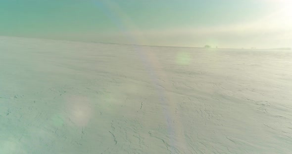 Aerial View of Cold Winter Landscape Arctic Field Trees Covered with Frost Snow Ice River and Sun alt