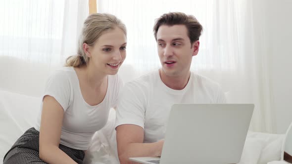 Couple using laptop for online shopping or playing the internet