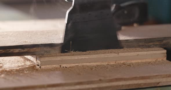 Woodworker cutting a piece of wood using a jigsaw alt