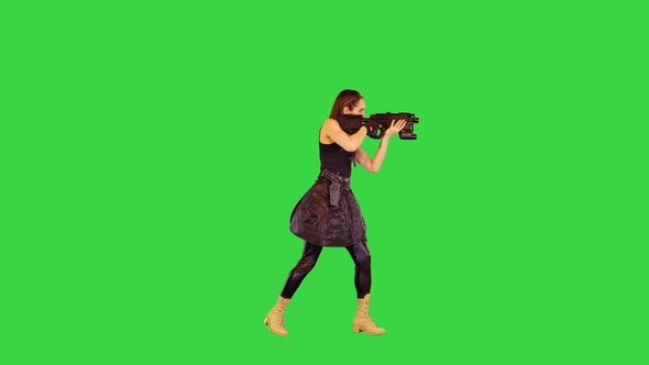 Female Anime Character with a Gun Takes an Aim and Makes a Several Shots on a Green Screen Chroma