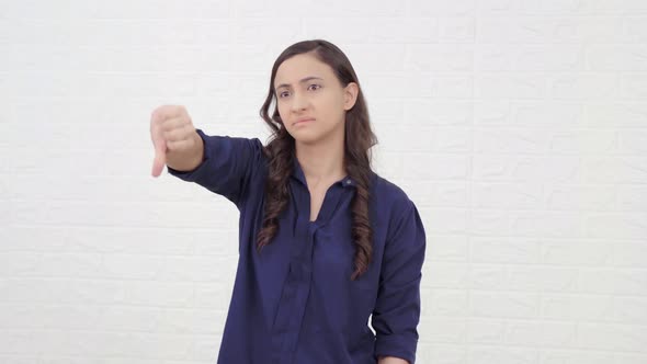 Indian woman showing thumbs down alt