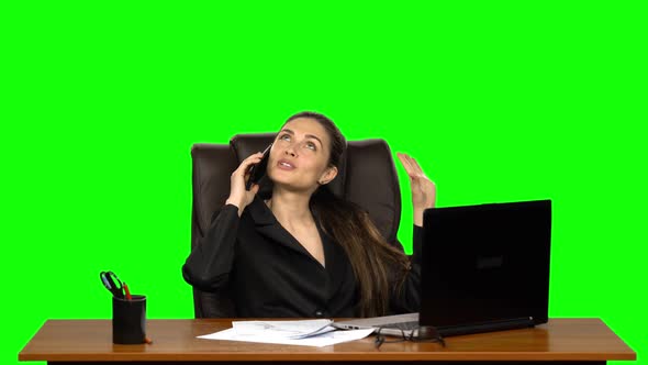 Businesswoman Flirting on the Phone From the Workplace. Green Screen. Studio alt