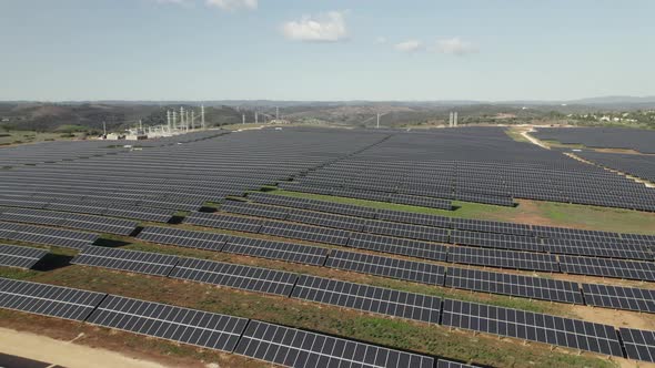Drone flying over solar panels in Portuguese countryside, Lagos. Aerial panoramic view