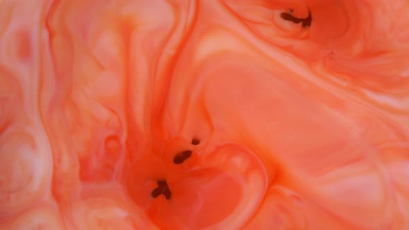 Ink in Water. Red and Orange Ink Reacting in Water Creating Abstract Background