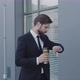 Business Person Holding Coffee To Go Having Break