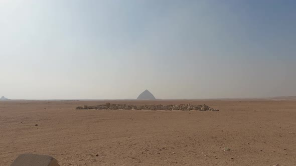 Establishing shot of Egyptian desert with Bent Pyramid in horizon, Dahshur. Egypt alt