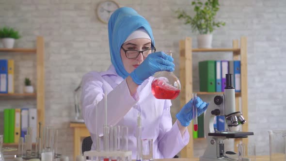 Muslim Woman Scientist Chemist in National Scarf Working in the Lab Close Up Slow Mo alt