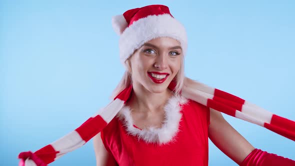 Cute Young Woman in Santa Claus Costume Dancing