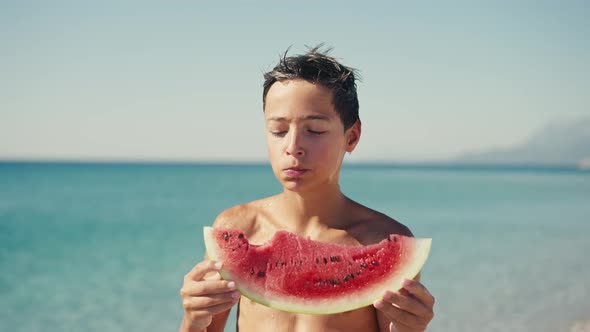 Boy Eating Watermelon on the Beach Summertime alt