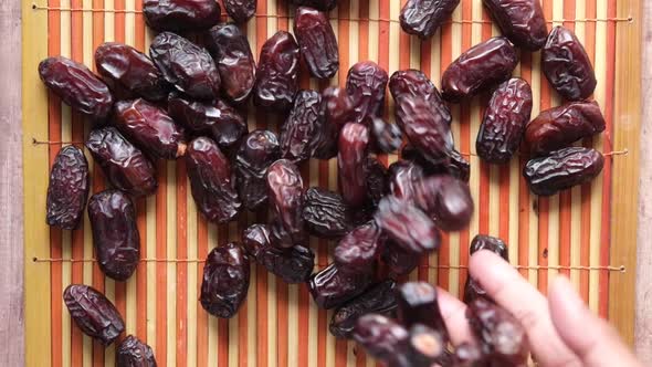 Slow Motion of Dropping Fresh Date Fruit on Table alt