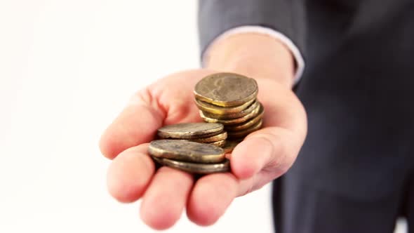 Mid-section of man holding coins alt