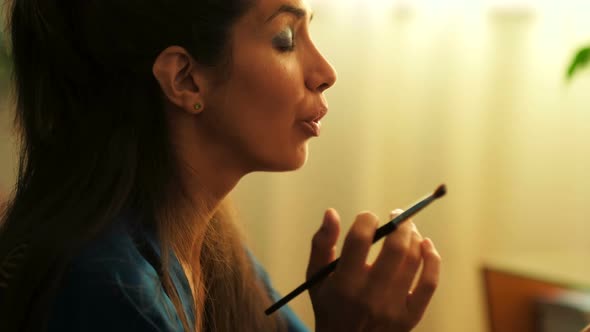 Woman Using Makeup Brush at Home 4k alt