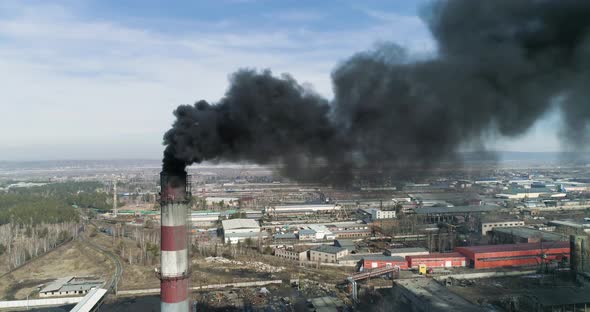 Coal-fired Smokestack Releasing Black Smoke Into the Air alt