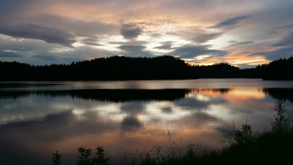 Norwegian Lake at Sunset Timelapse. Scandinavian Landscape in  UltraHD . alt