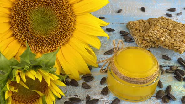 Sunflower and products based on it: honey, vegetable oil, seeds and sweets. alt