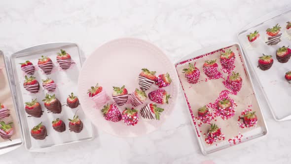 Flat lay. Step by step. Arranging a variety of chocolate dipped strawberries on a pink cake stand. alt