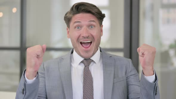 Portrait of Excited Middle Aged Man Celebrating Success alt