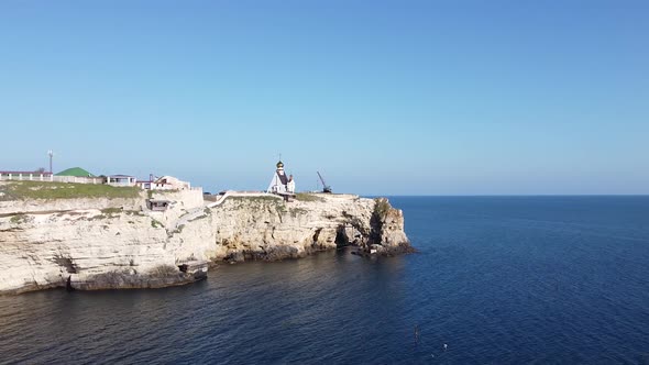 Drone footage of church on a cliff and sea view