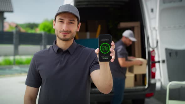 Video of delivery man holding mobile with mobile app. Shot with RED helium camera in 8K. alt