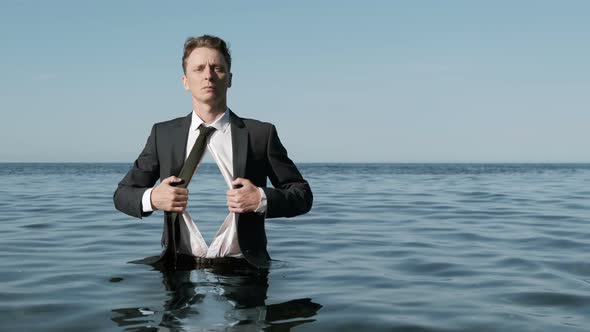 Businessman Standing in Water With Sea Inside a Chest