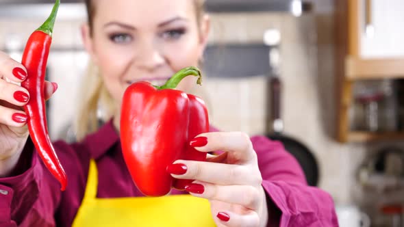 Woman Shows Chilli and Bell Pepper