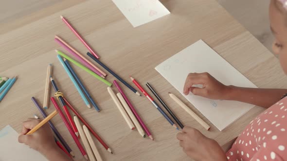Children Drawing Postcards on Table alt