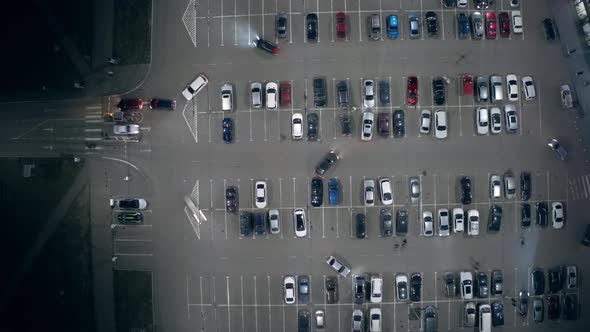 A Timelapse Car Traffic on a Big Parking Lot Near the Supermarket at Night alt