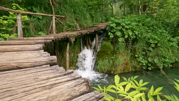 Plitvice Lakes National Park, Croatia. Waterfall Flowing Into Lake Under Wooden Boardwalk Among alt