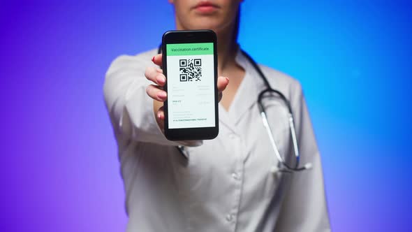 Woman Doctor in Medical Uniform Showing Vaccination Passport with Qr Code on Phone International alt