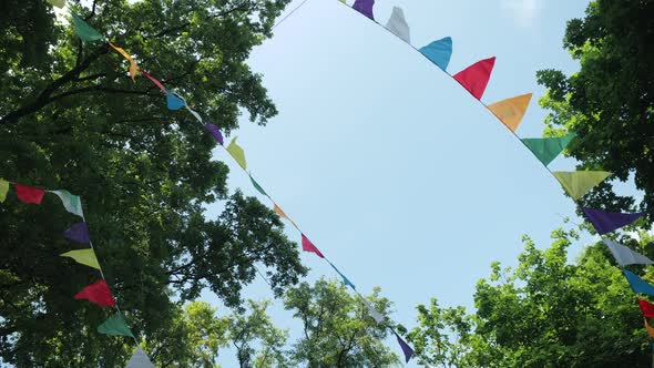 Festive Garland of Multi-colored Paper Flags for the Holiday. Scenery for a Children's Birthday alt