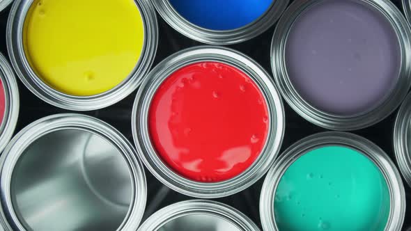 Aluminium Cans with Vivid, Colorful Paint Inside Stacked on the Floor of a Warehouse. Top View alt