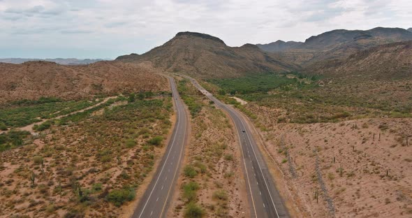 Dramatic Clouds Over the Mountains are a Desert Cactus Mountain Landscape Near the Highway in alt