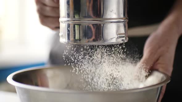 Woman Sifting Flour in a Bowl alt