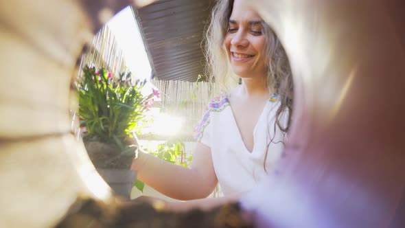 Girl Smells Replacing Houseplant Close View From Pot Inside