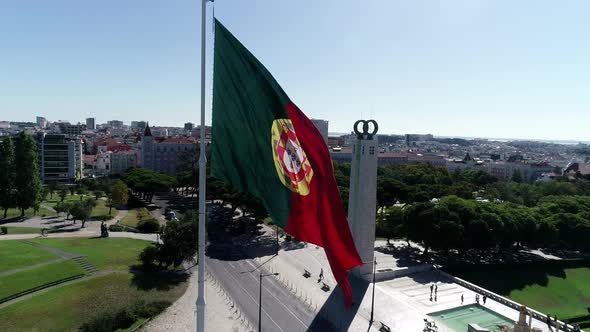 Close Up Aerial View of Portugal Flag Waving in the Wind on Eduardo VII Park Lisbon alt